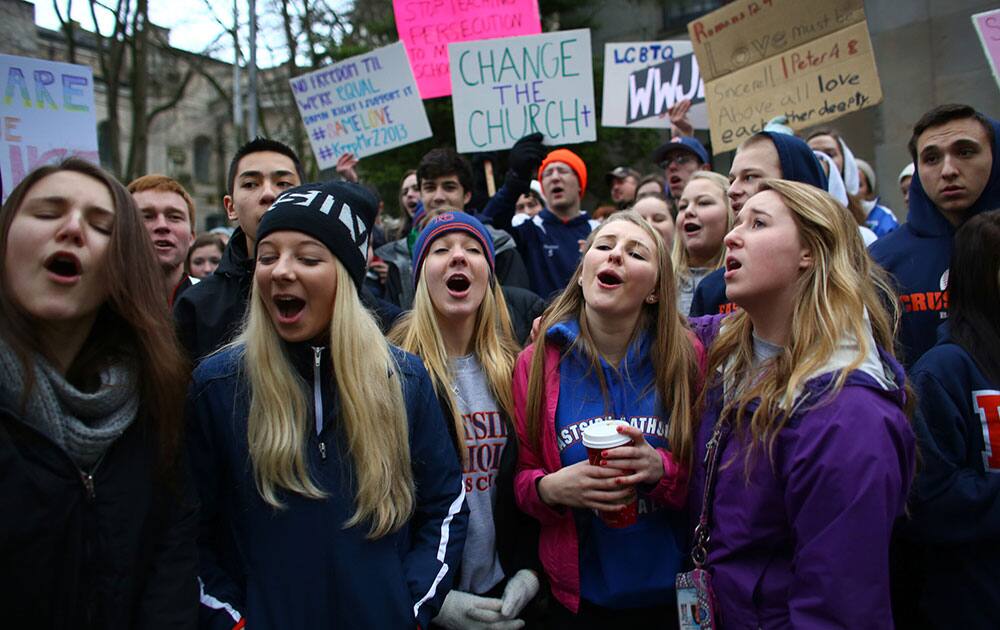 Students sing vocalist Mary Lambert`s lyrics to the song `Same Love` by Macklemore & Ryan Lewis outside of the Chancery building for the Archdiocese of Seattle.