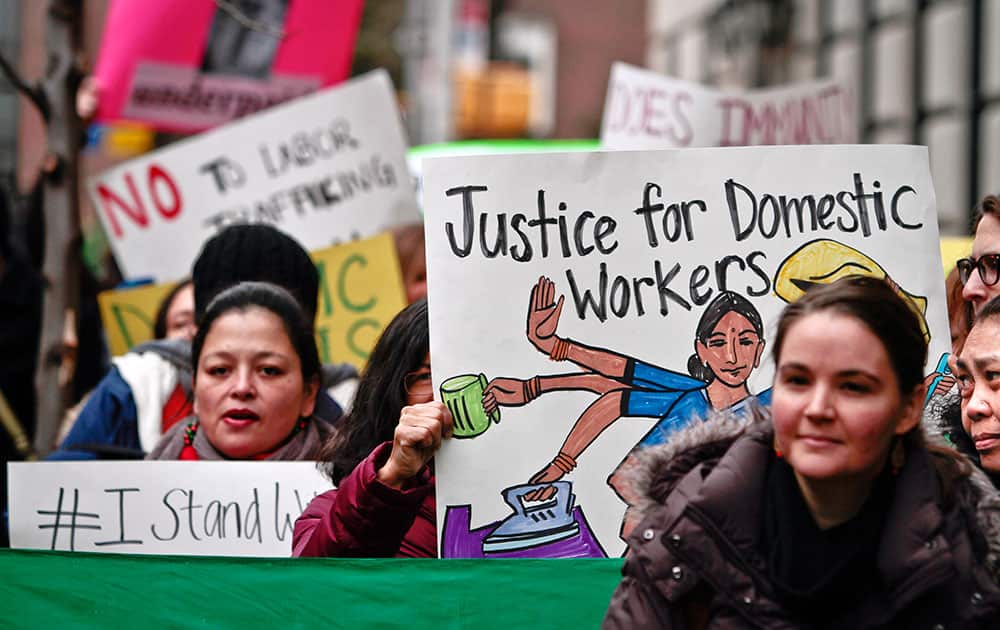 Members and supporters from a coalition of organizations supporting domestic workers, rally outside the Indian consulate, in New York. About two dozen protesters gathered outside the Consulate General of India in New York in support of the housekeeper, carrying signs saying `Justice for domestic workers: hold diplomats accountable` and `Overworked, underpaid.`