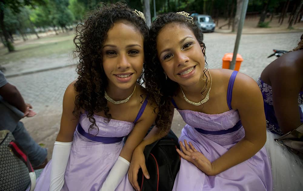Twins Lara and Clara Santos pose for a photo before attending a debutante ball organized by the Pacifying Police Unit program, in Rio de Janeiro, Brazil.
