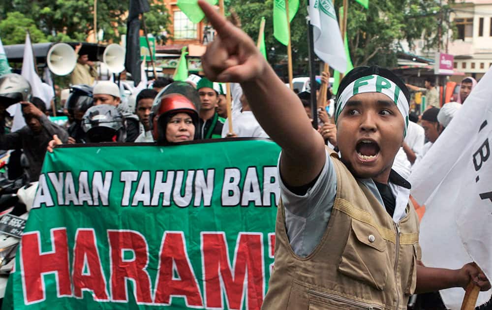 A Muslim man shout slogans during a protest against Christmas and New Year celebrations in Banda Aceh, Aceh province, Indonesia.