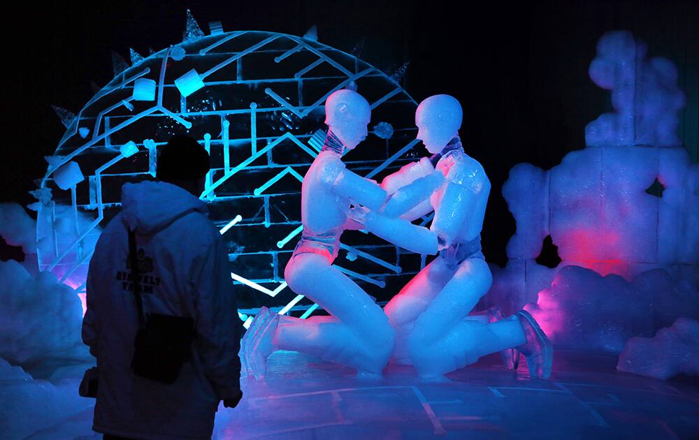 A visitor watches sculptures on the theme `Expedition ins ewige Eis` (Expedition into the Perpetual Ice) which are on display in the new ice world at Karls Erlebnishof in Roevershagen, Germany.
