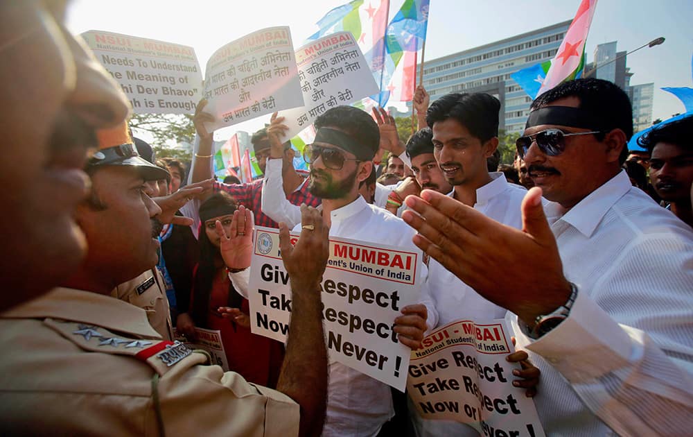 Policemen stop a group of the student wing of ruling Congress party, National Students Union of India (NSUI), during a protest outside the US consulate in Mumbai.