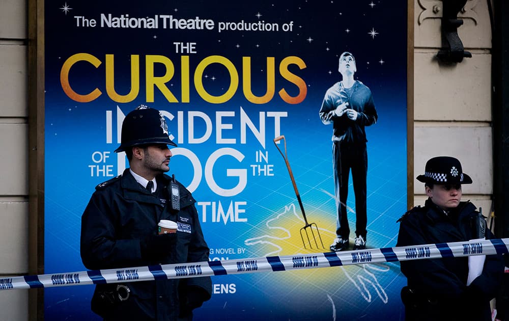 Police stand outside The Apollo Theatre in London, Authorities are carrying out a structural assessment at the Apollo Theatre after the partial collapse of its ceiling injured more than 75 people in the packed auditorium.