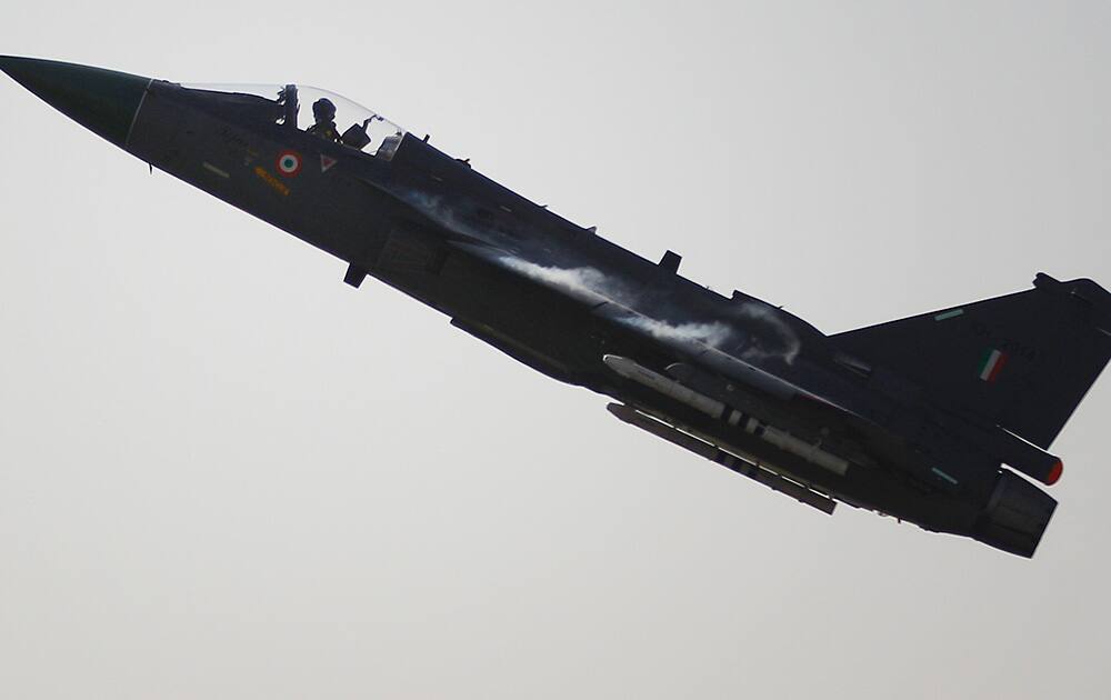 India`s indigenously designed and developed combat aircraft Tejas takes off during its air display at Hindustan Aeronautics Limited airport in Bangalore.