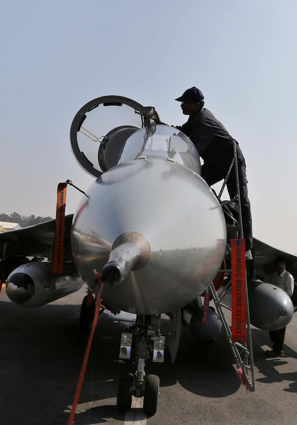 An engineer closes the cockpit of India`s indigenously designed and developed combat aircraft Tejas after its air display at Hindustan Aeronautics Limited airport in Bangalore.