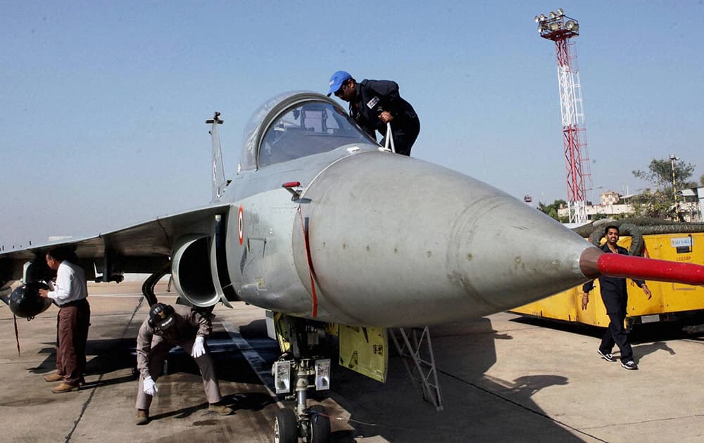 Air Force engineers and technicians work on a LCA Tejas during initial operational clearance of LCA Tejas for induction into the IAF, in Bengaluru.