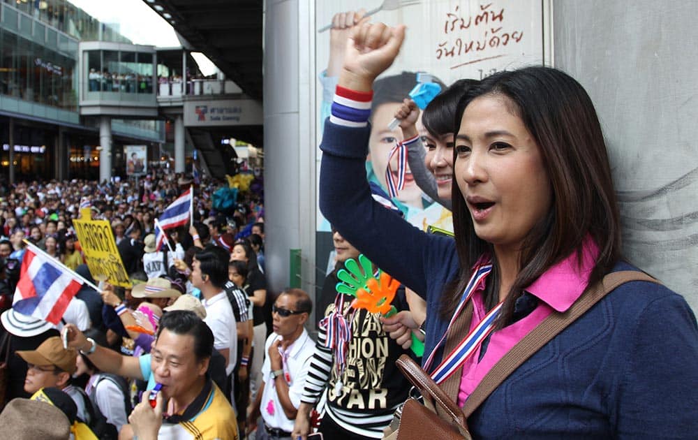 Thai office workers chant slogans during an anti-government rally at a business district in Bangkok.