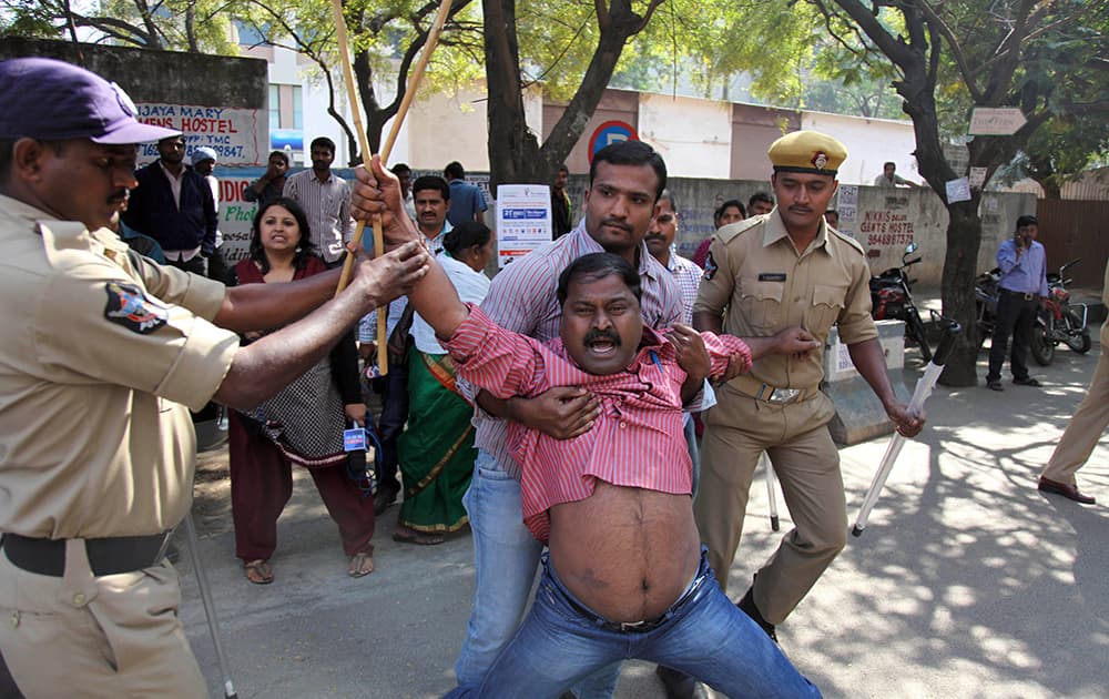 Policemen detain a Left Party activist during a protest against the alleged mistreatment of New York based Indian diplomat Devyani Khobragade, near the US Consulate in Hyderabad.