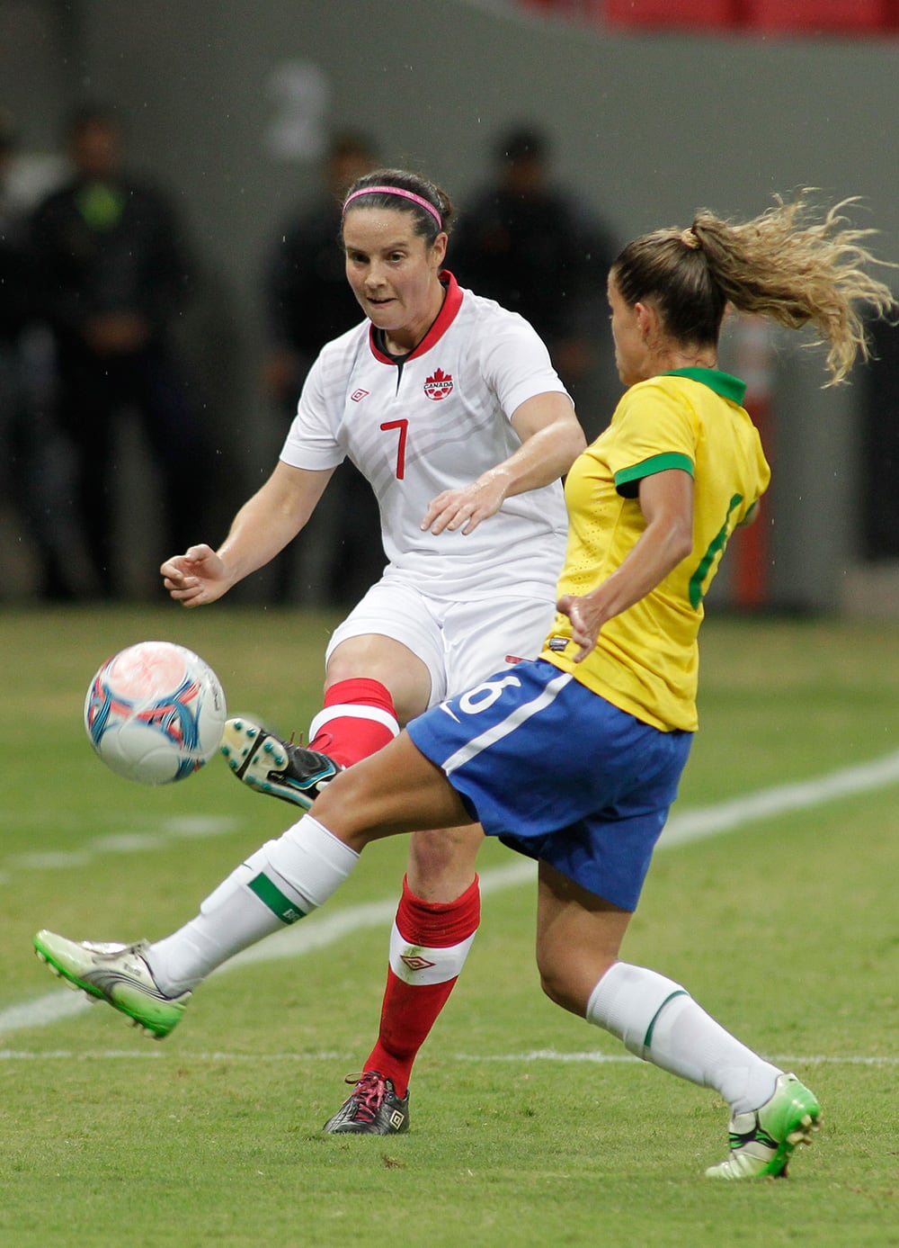 Canada`s Rhian Wilkinson (7) kicks the ball past Brazil’s Tamires Cassia, during a soccer match at the International Women`s Football Tournament in Brasilia, Brazil.