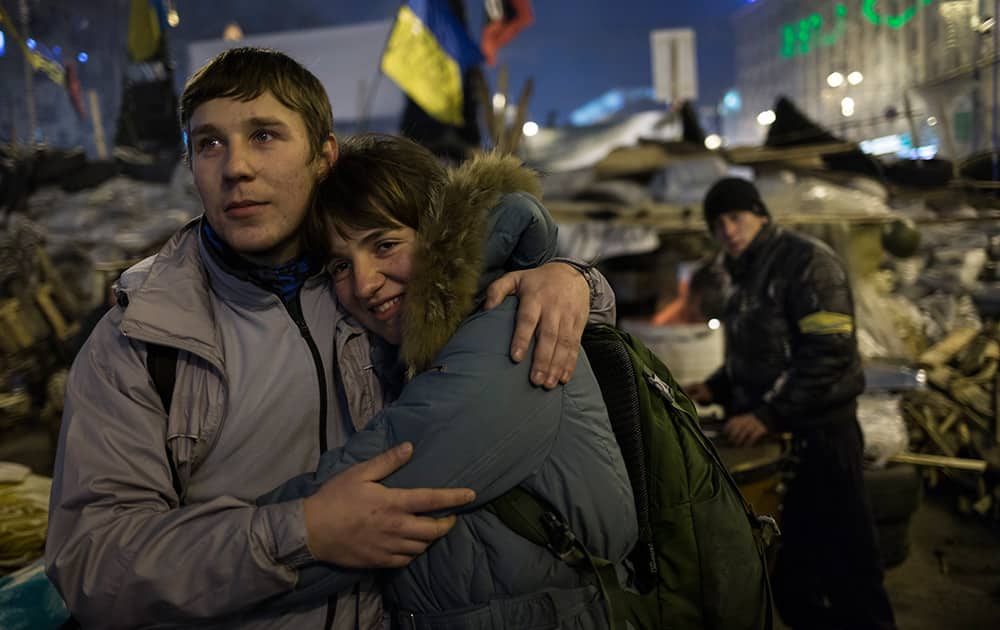 A young couple embrace each other as they look at the stage during a concert after a pro-European Union rally in the Independence Square in Kiev, Ukraine.