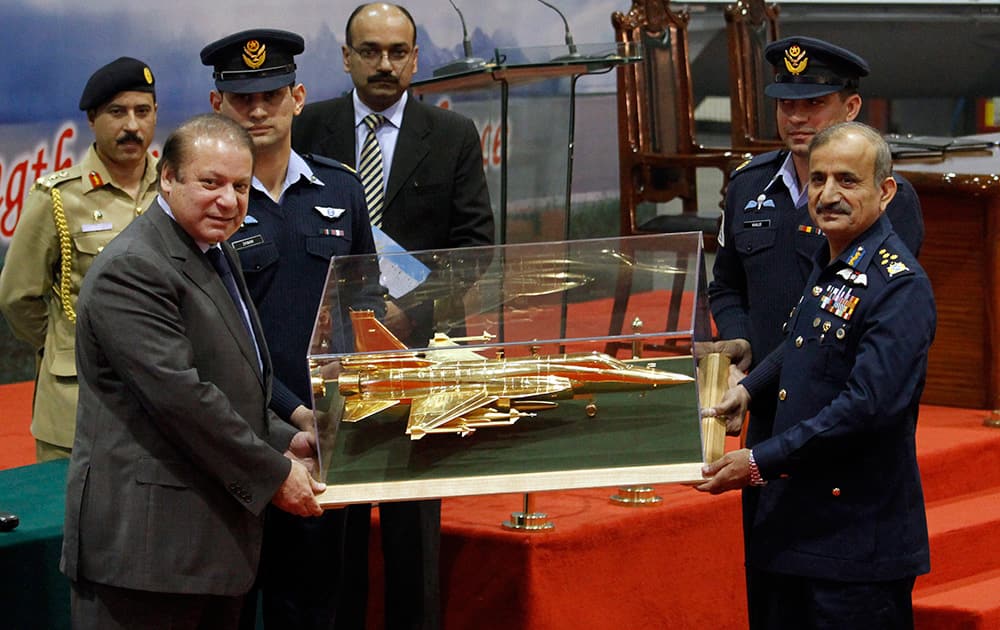 Pakistan Air Force Chief Air Chief Marshal Tahir Rafique Butt presents a model of the JF-17 Thunder aircraft to Prime Minister Nawaz Sharif, left, during the 50th JF-17 Thunder Aircraft Rollout and Launching of Block II ceremony in Kamra air base, Pakistan.