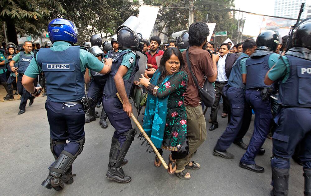 Bangladeshi policemen try to keep activists and others from marching towards the Pakistan Embassy in Dhaka, Bangladesh. The activists were protesting against the Pakistan parliament’s resolution expressing concern over last week`s execution of Jamaat-e-Islami leader Abdul Quader Mollah for war crimes committed during Bangladesh`s 1971 independence war against Pakistan.