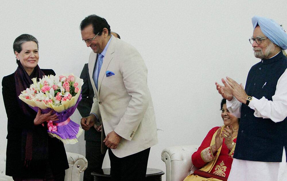 Prime Minister Manmohan Singh claps as MP Francisco Sardinha greets UPA Chairperson Sonia Gandhi during Christmas celebration by Parliamentarians in New Delhi.
