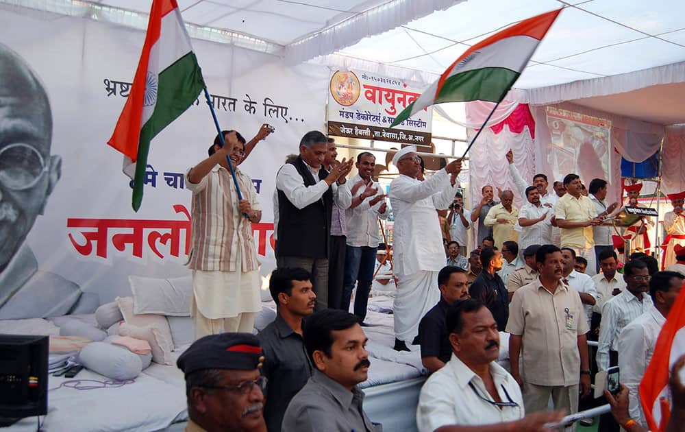 Anna Hazare, center right, who is on the 8th day of his hunger strike demanding that an anti-graft legislation called ‘Lokpal’ is passed, waves the Indian flag with supporters at Ralegan Siddhi, Maharashtra state, India.