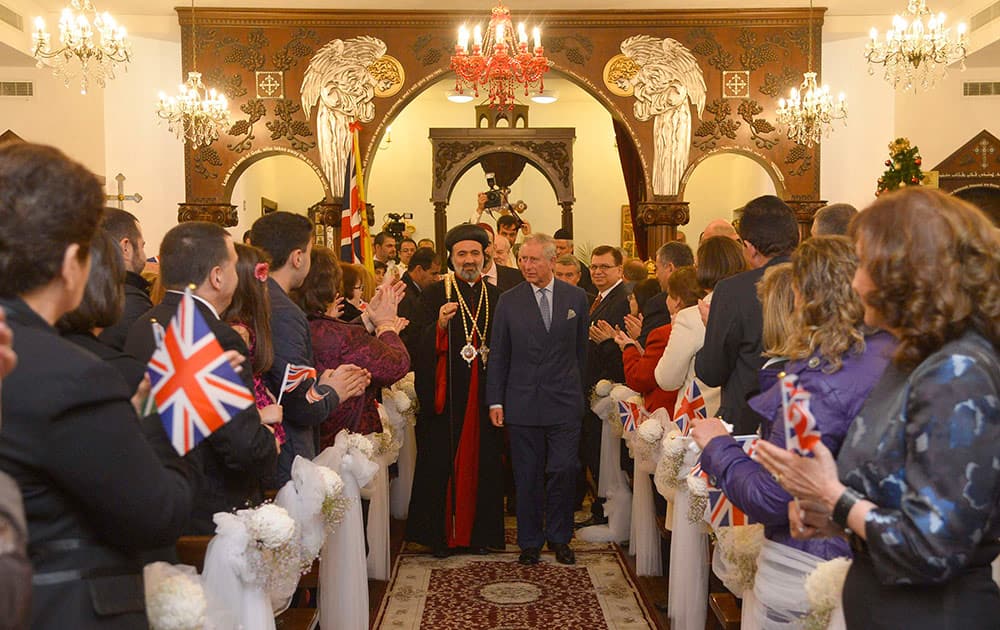 Britain`s Prince Charles, center right, accompanied by the Archbishop of the Syrian Church in the United Kingdom, Archbishop Athanasius, visits a Syriac (Syrian) Orthodox Church in west London.