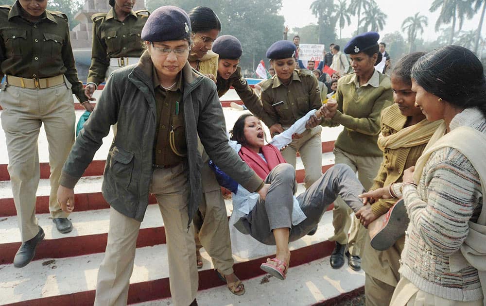 Police arrest an AISF activist during a protest demonstration against West Bengal government`s proposed International Convention Center in Patna.