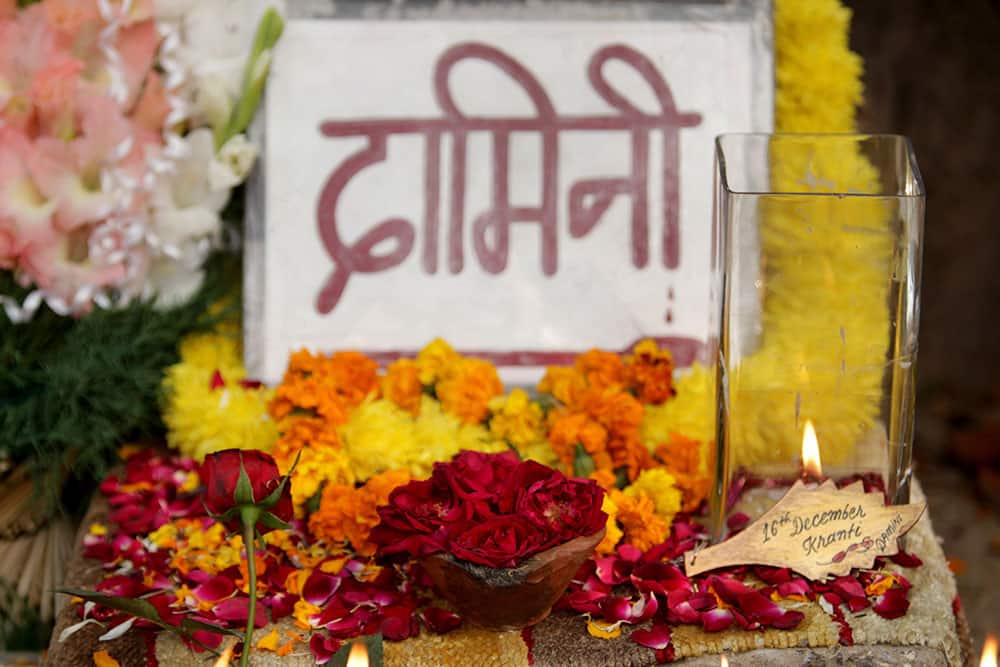 Flowers and candles are placed near a placard reading: “Damini”, a symbolic name given to a gang-raped victim, in New Delhi.