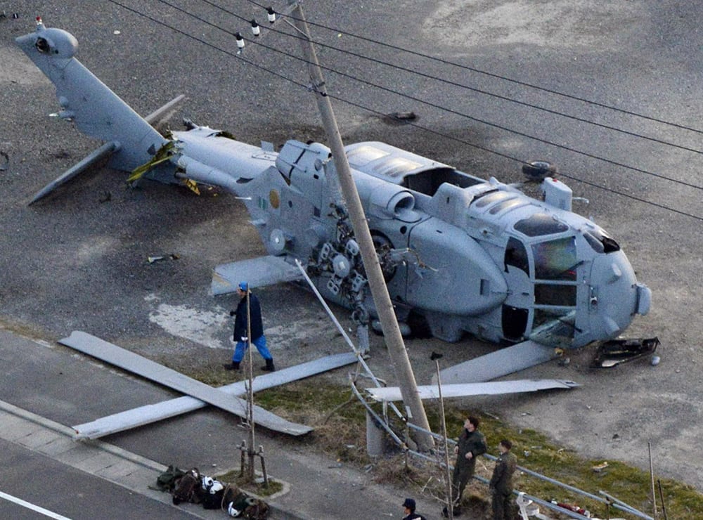 A US Navy MH-60 helicopter lies on the ground after making an emergency landing in Miura city, near Tokyo. US Forces Japan spokesman David Honchul said two injured crew members from the helicopter were taken to a hospital for treatment. Kyodo News agency said one suffered a broken leg and the other had bruises.