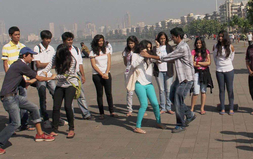 Students perform street-play in memory of Nirbhaya and other victims of rape and violence at Marine Drive in Mumbai.