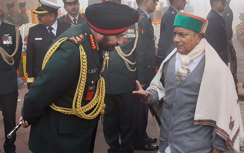 Defence Minister A K Antony sharing a word with Army Chief Gen Bikram Singh after paying homage to the martyrs at Amar Jawan Jyoti at India to mark the `Vijay Divas` in New Delhi.