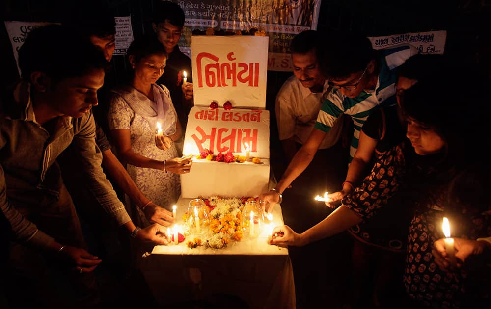 Indians place candles as they remember last year’s gang rape and murder of a young woman in New Delhi, in Ahmadabad.
