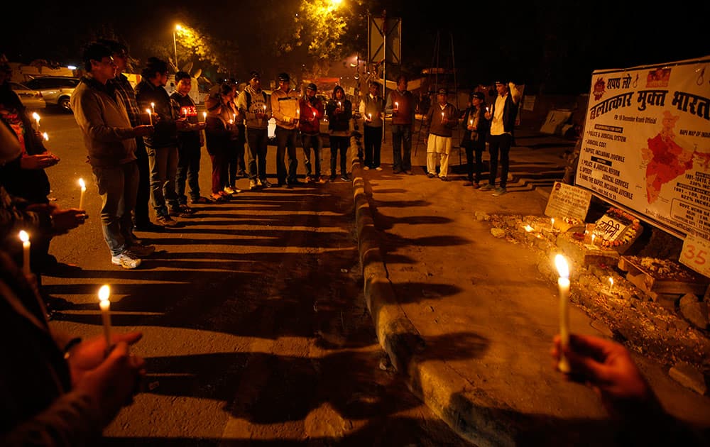 Indians hold candles as they commemorate last year’s gang rape and murder of a young woman in New Delhi.
