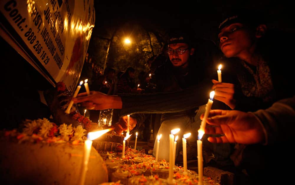 Indians light candles as they commemorate last year’s gang rape and murder of a young woman in New Delhi.