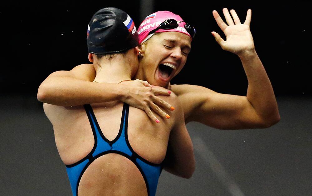 Yuliya Efimova from Russia reacts with a teammate after winning the woman`s 4x50 meter Medley final during the European Short Course Swimming Championships in Herning, Denmark.