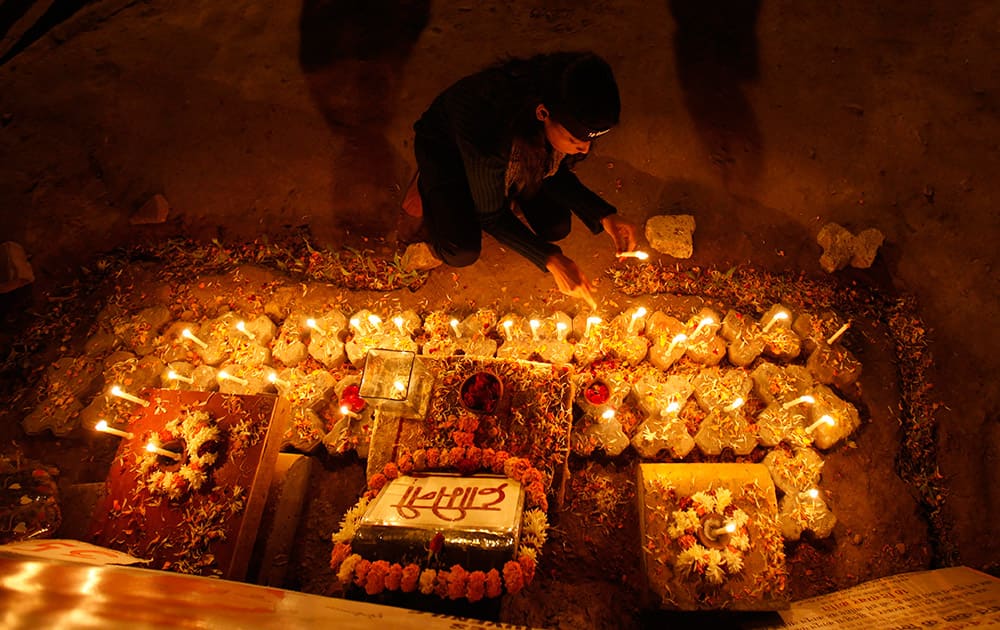 A girl places candles to commemorate last year’s gang rape and murder of a young woman in New Delhi. Public anger against crimes against women exploded after a fatal gang-rape of a young woman on a New Delhi bus on Dec.16, 2012.