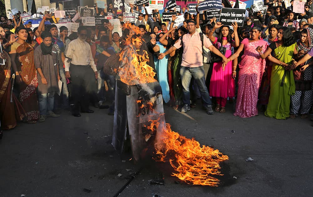 Indian gay rights activists shout slogans and burn placards, with section 377 written on them, during a protest against a Supreme Court verdict that upheld section 377 of the Indian Penal Code that criminalizes gay sex, in Bangalore.
