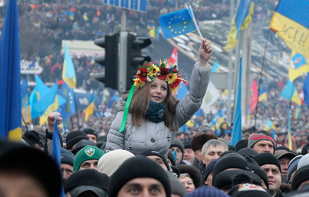 Pro-European Union activists, one waving the EU flag, gather during a rally in Independence Square in Kiev, Ukraine.