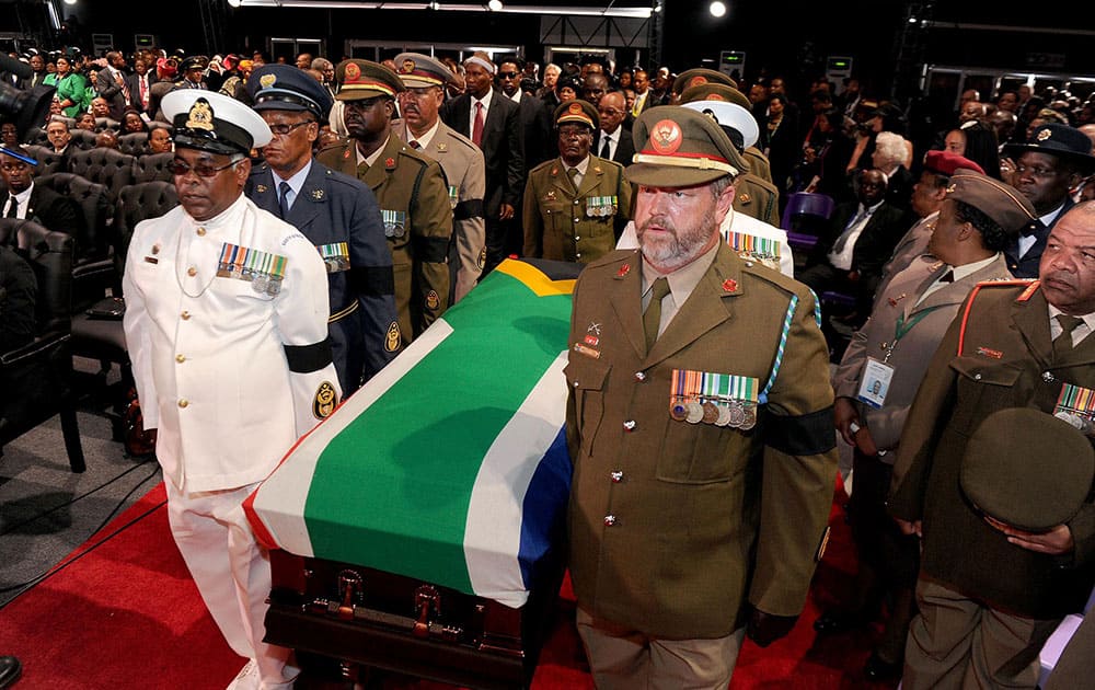 The casket bearing the remains of former South African President Nelson Mandela is brought into a makeshift tent for his funeral service for in Qunu, South Africa.