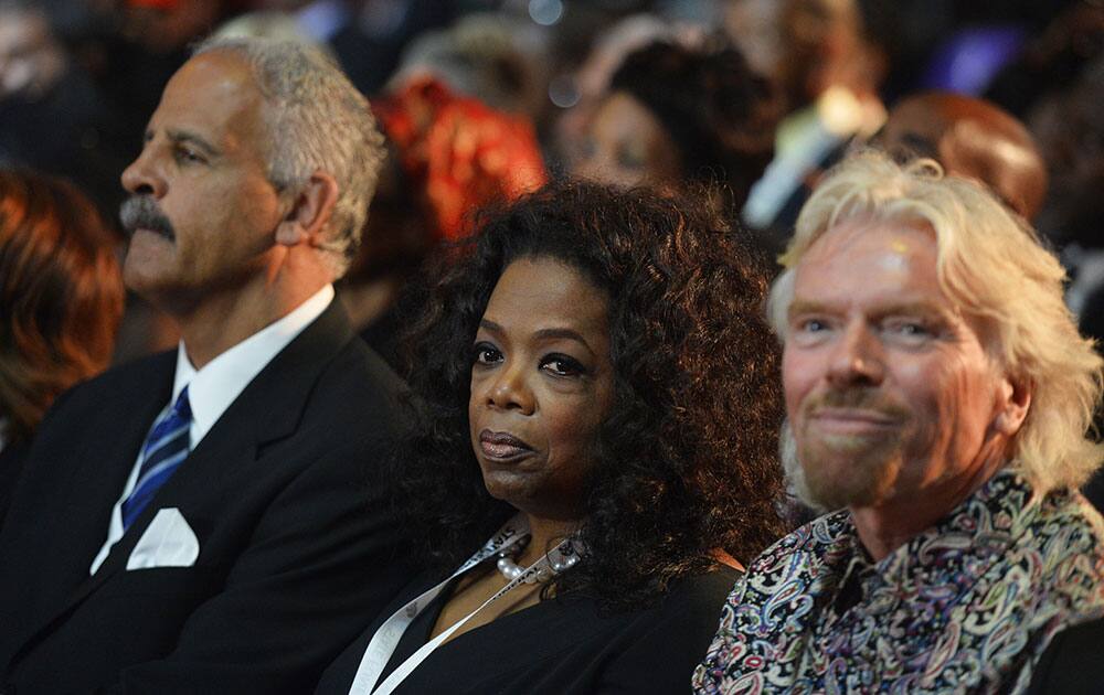British entrepreneur Richard Branson, right and television host Oprah Winfrey attend the funeral service for former South African President Nelson Mandela in Qunu, South Africa.