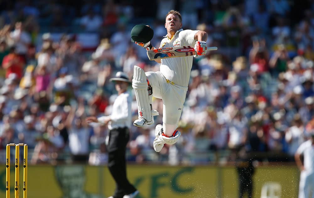 Australia`s Dave Warner leaps into the air after scoring a century during the second innings on the third day of their Ashes cricket test match against England, in Perth.