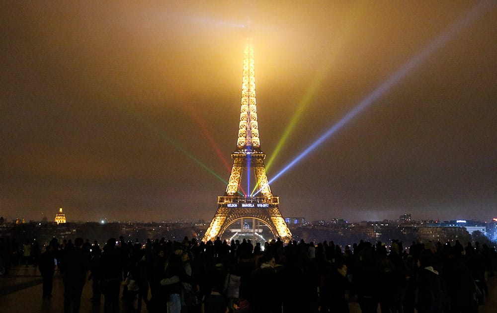 `Nelson Mandela 1918-2013` is projected with color lighting on the Eiffel Tower in Paris. The Eiffel Tower will be illuminated with South African colors for three days as the iconic leader will be buried on Sunday close to his house in Qunu, South Africa.