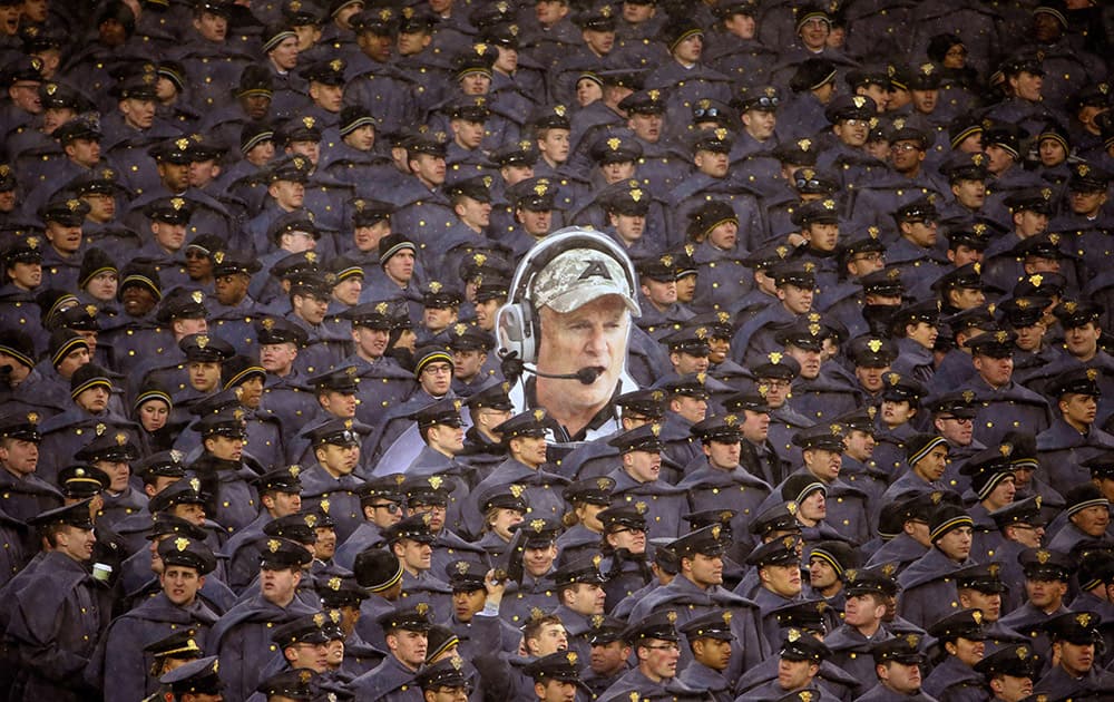 Army cadets hold a large photo of Army head coach Rich Ellerson during an NCAA college football game against Navy, in Philadelphia. Navy won 34-7.