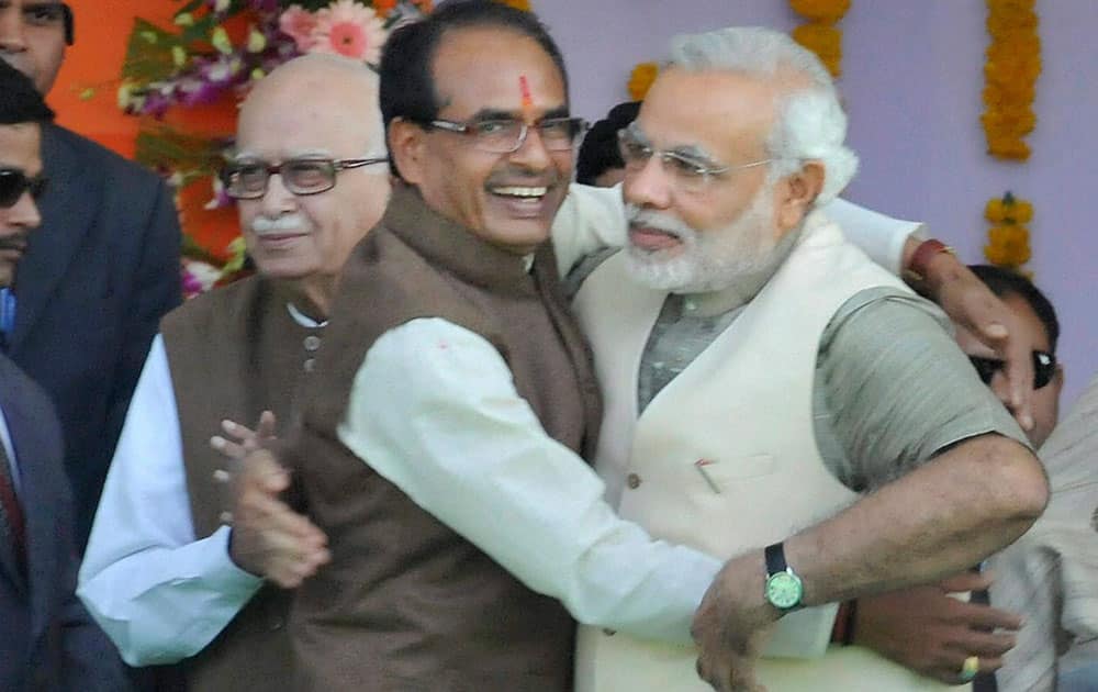 BJP Prime Ministerial candidate Narendra Modi greets Madhya Pradesh Chief Minister Shivraj Singh Chouhan during his swearing-in ceremony in Bhopal.
