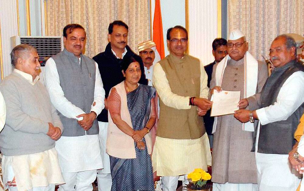 Madhya Pradesh Chief Minister Shivraj Singh Chouhan gives letter to Governor Ram Naresh Yadav after he was elected Leader of BJP Legislative Party at Raj Bhawan, in Bhopal.
