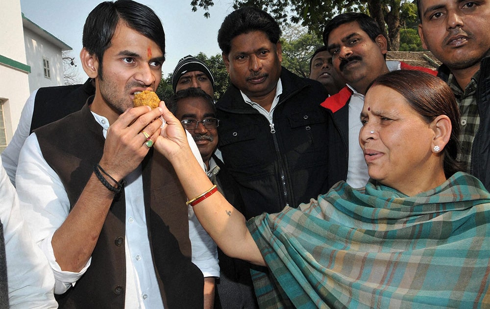 Rashtriya Janata Dal (RJD) leader Rabri Yadav giving sweet to her son after party superemo and her husband Lalu Prasad was granted bail in fodder scam, in Ranchi.