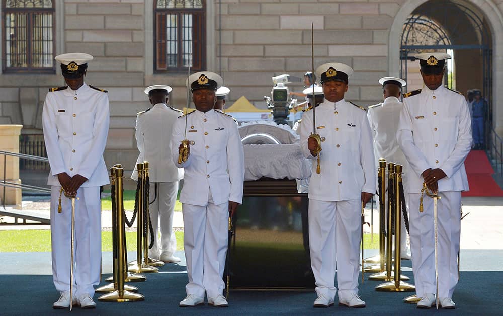 South African Naval personnel stand guard around the casket of former South African president Nelson Mandela is carried to the Union Buildings on the final day of his lying in state in Pretoria, South Africa.