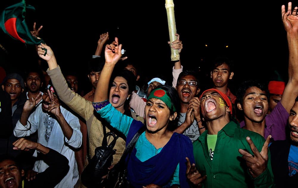 Social activists and supporters of Awami League party celebrate outside Central Jail, where opposition leader Abdul Quader Mollah was hanged, in Dhaka, Bangladesh.