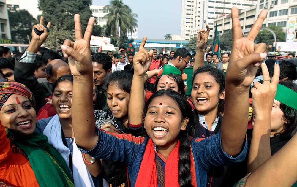 Bangladeshi social activists and others celebrate after the Supreme Court cleared the way for the execution of Abdul Quader Mollah, an opposition leader convicted of war crimes in Dhaka, Bangladesh.
