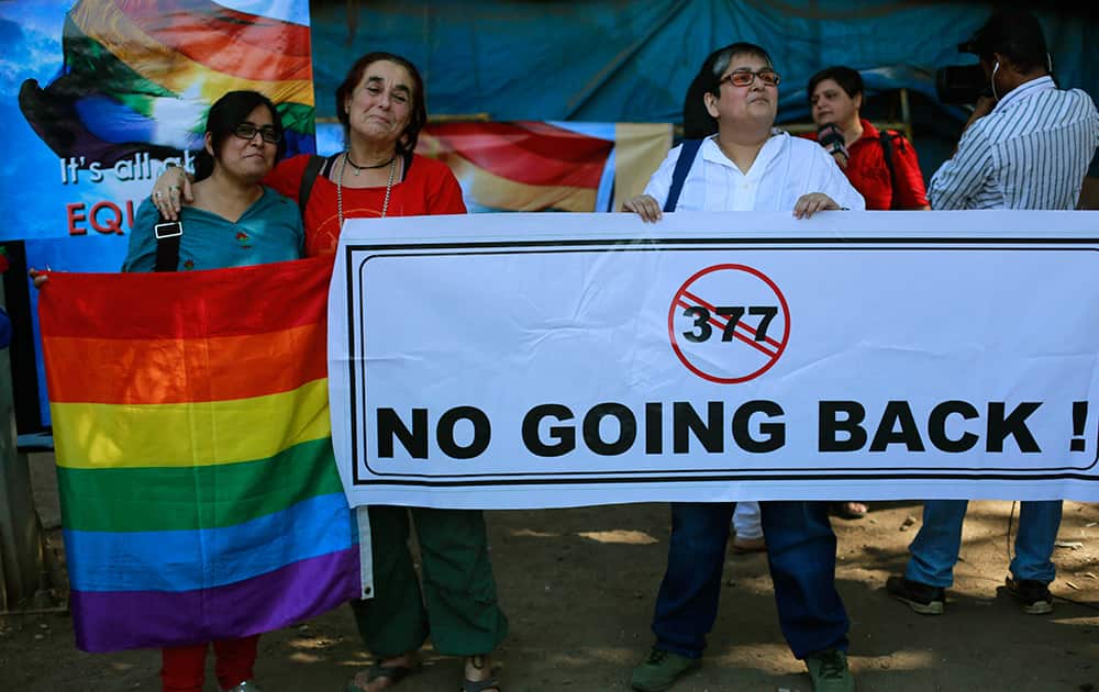 A group of Indian activists hold a banner against section 377 of the Indian Penal Code that criminalizes homosexuality during a protest in Mumbai.
