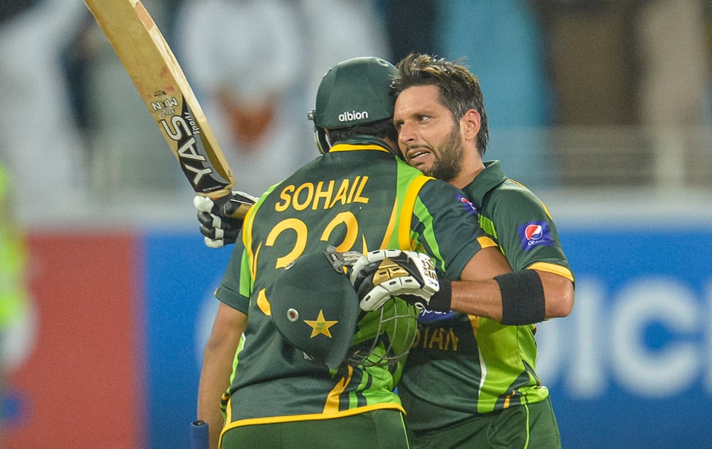 Pakistan`s batsman Shahid Afridi, celebrates with Sohail Tanvir the victory of the match, during the first T20 cricket match between Pakistan and Sri Lanka, at the DSC Cricket Stadium Dubai
