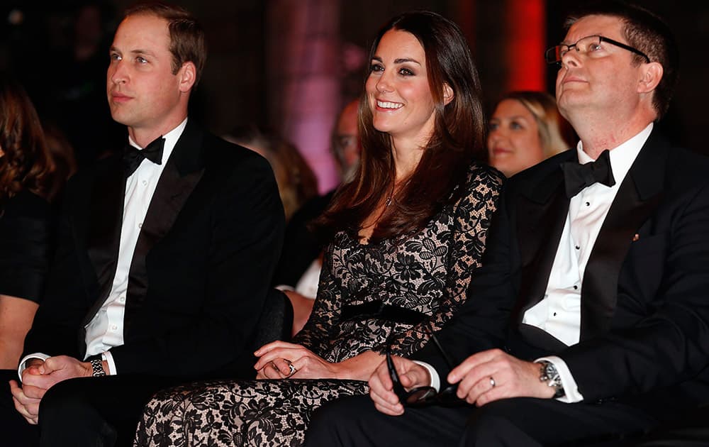 From left, Britain`s Prince William, the Duke of Cambridge, and his wife Kate, the Duchess of Cambridge, sit with Natural History Museum Director Michael Dixon, before a screening of ` David Attenborough`s Natural History Museum Alive 3D` , at the Natural History Museum, in London.