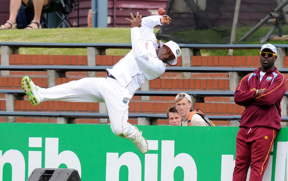 West Indies Tino Best attempts to take a catch on the boundary off the bat of New Zealand`s Trent Boult on the second day of the second international cricket match at the Basin Reserve in Wellington, New Zealand.