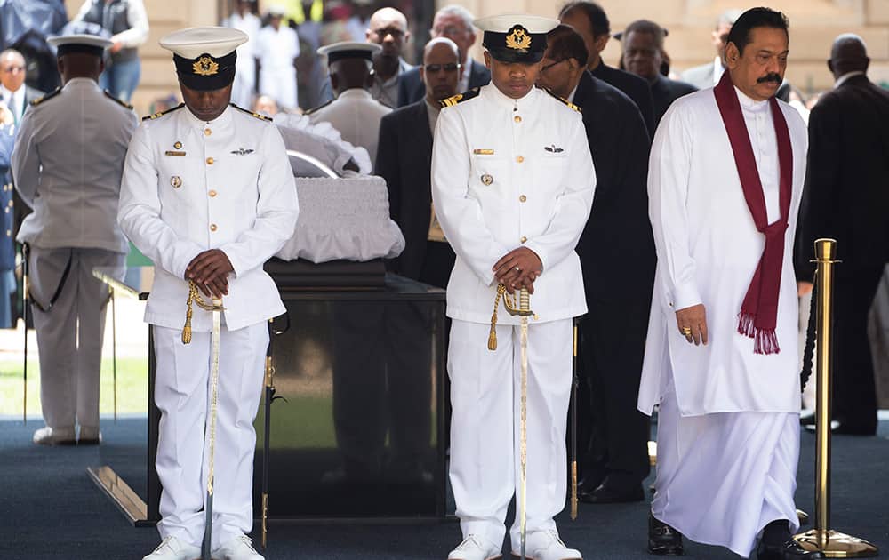 Sri Lanka`s President Mahinda Rajapaksa leaves after paying his respects to former South African President Nelson Mandela during the lying in state at the Union Buildings in Pretoria, South Africa.