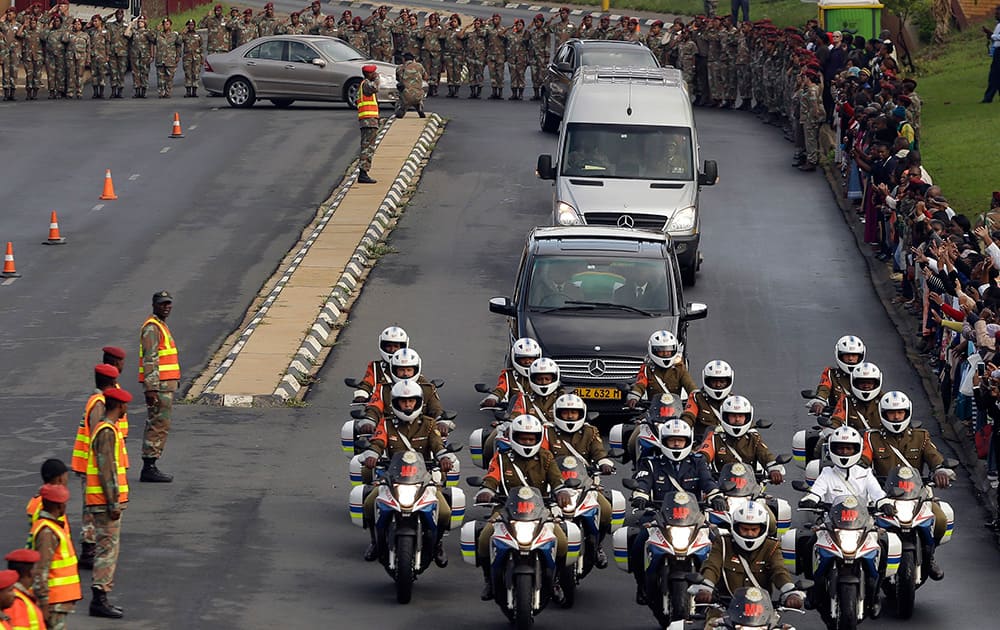 Defense force personnel and hospital staff salute a procession for former South African president Nelson Mandela as it leaves the military hospital in Pretoria, South Africa.