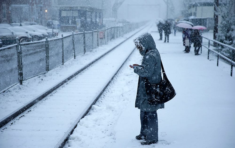 A commuter waits on a train during a winter snowstorm in Philadelphia. Accumulations of 3 to 6 inches were expected as the National Weather Service issued a winter storm warning for the Eastern Seaboard, including Baltimore, Washington, D.C., Philadelphia and Wilmington, Del.