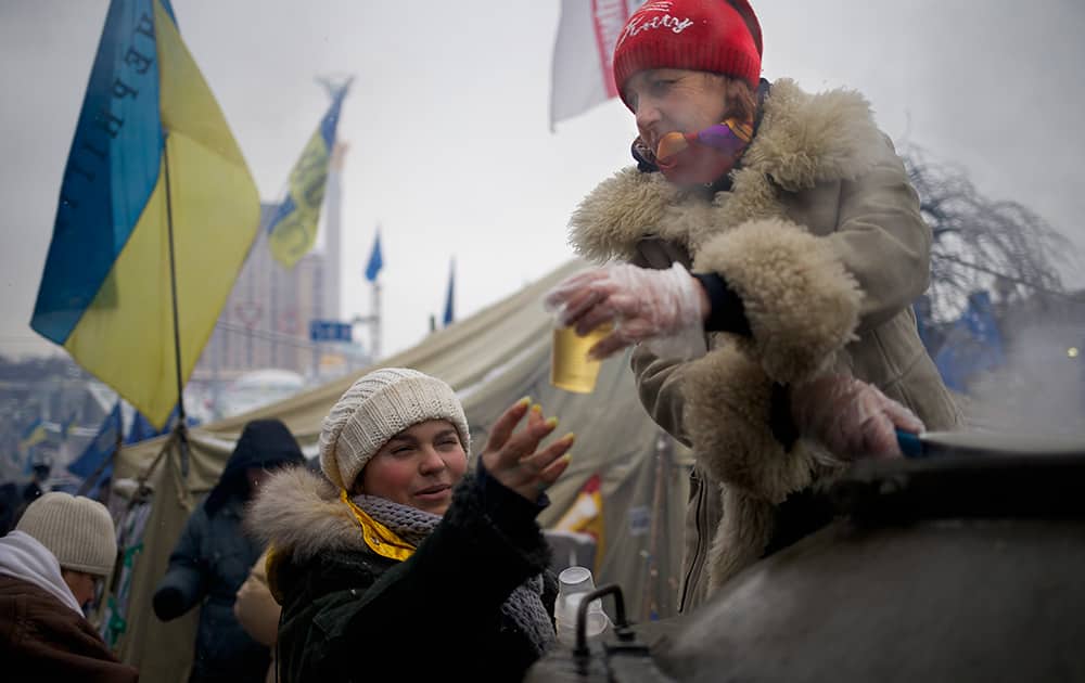A volunteer distributes hot tea for Pro-European Union activists in Independence Square in Kiev, Ukraine.